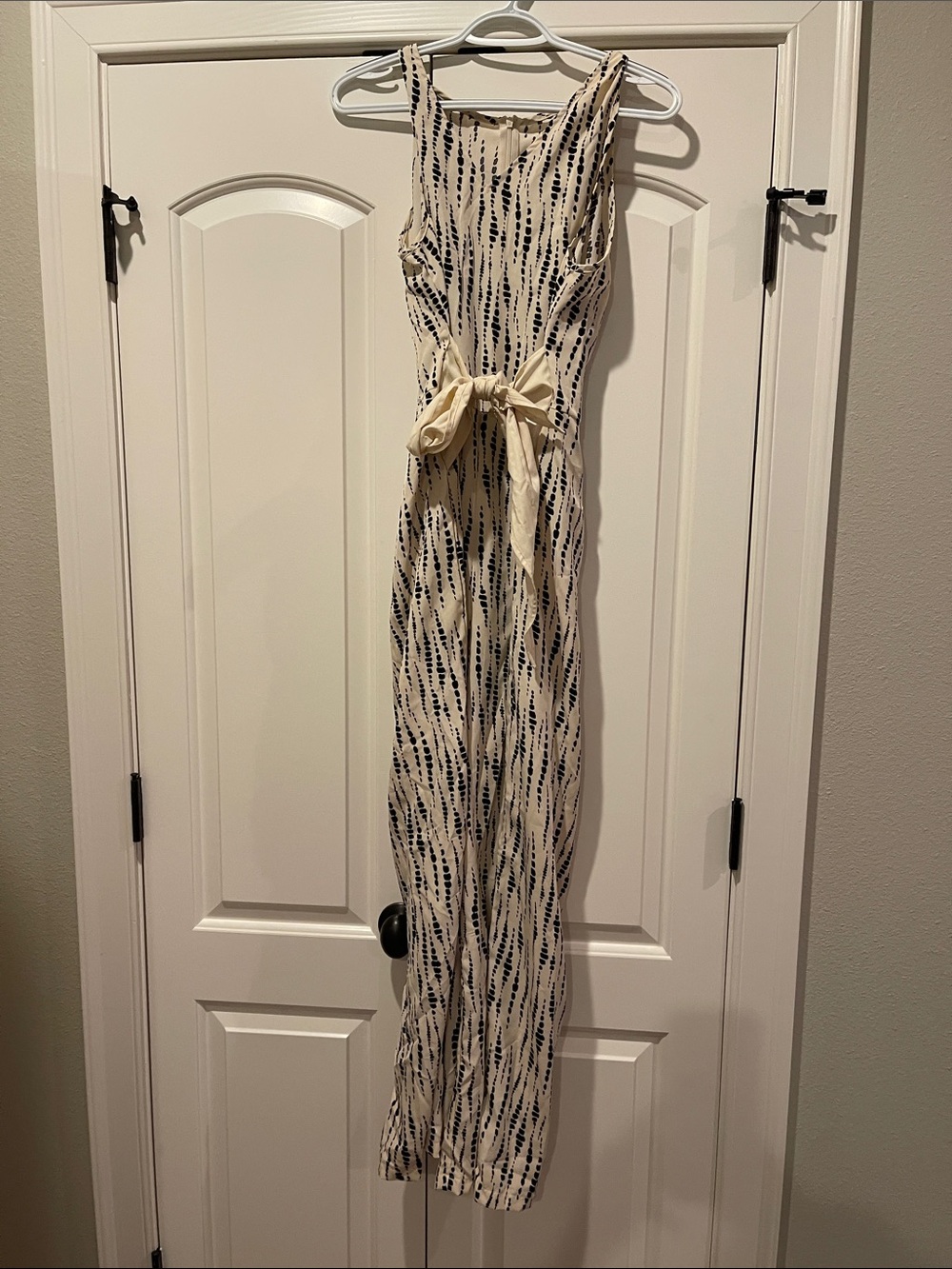 Sleeveless Cream Jumpsuit with Black Leaf Print and Waist Tie